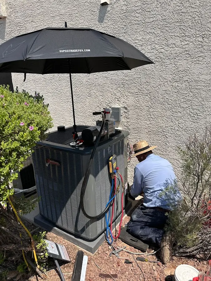 HVAC technician performing outdoor AC maintenance in Kemp Mill