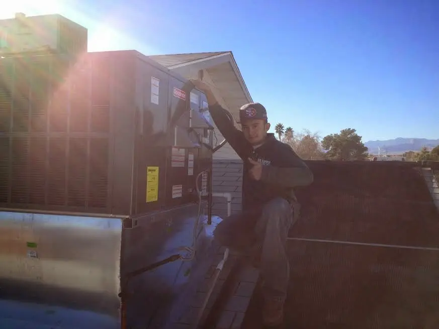 HVAC technician performing HVAC Inspection on a rooftop unit in Kemp Mill